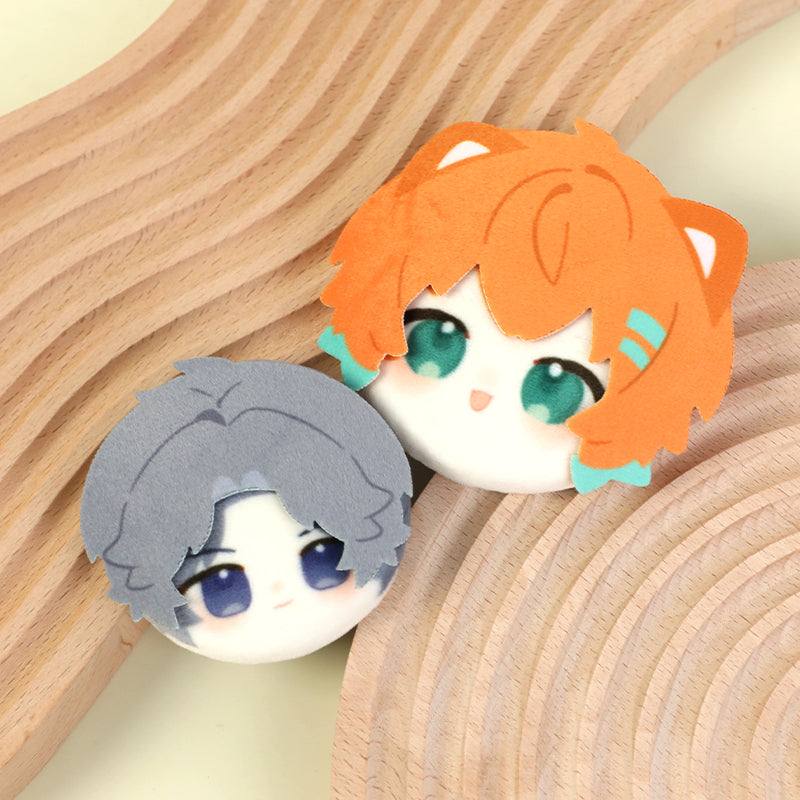 Cute custom 3D plush head button pins with anime faces, on a wooden surface