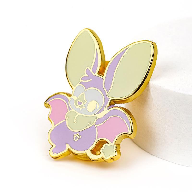 Custom hard enamel pin featuring a cute pastel bat with large ears and gold outline.